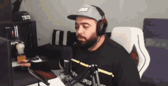 a man wearing headphones and a hat that says tbd3