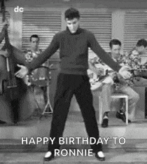 a man is dancing in front of a band .