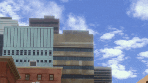 a blurry picture of a city skyline with a blue sky and clouds in the background