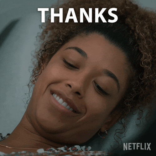 a woman with curly hair is smiling and the words thanks are above her