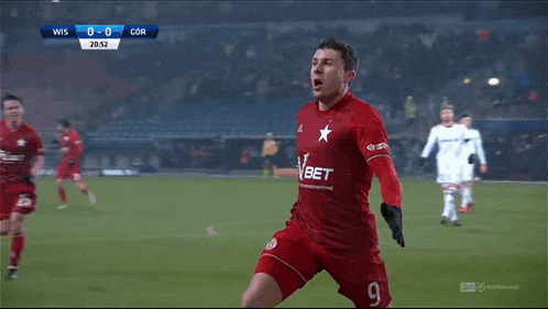 a soccer player wearing a red jersey with the number 9