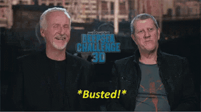two men are sitting in front of a sign that says deepsea challenge 30