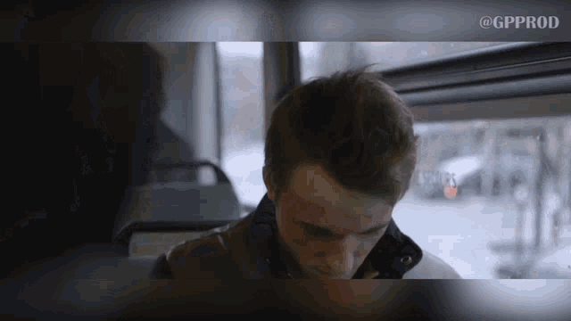 a man with blood on his face is sitting on a bus with the words @gpprod below him