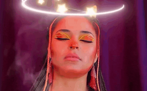 a woman with a halo on her head is wearing a red and yellow makeup look .