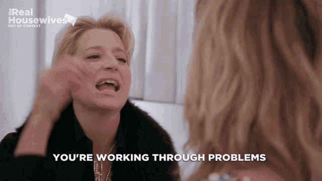a woman says you 're working through problems while another woman looks on