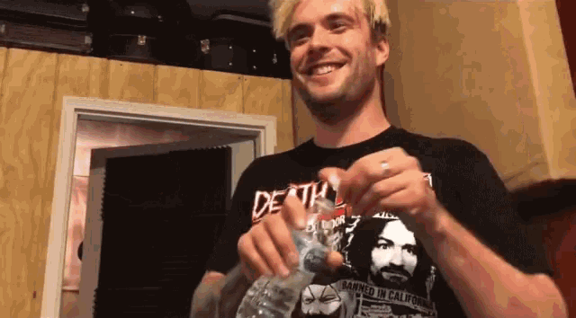 a man wearing a death shirt is smiling