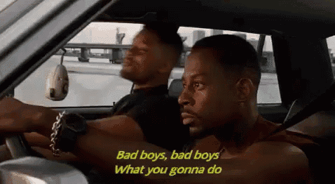 two men are driving a car and one of them is saying bad boys bad boys what you gonna do