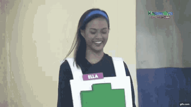 a woman with the name ella on her shirt is smiling