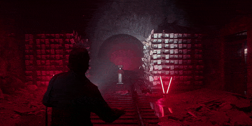 a person standing in a dark room with a light shining through the smoke