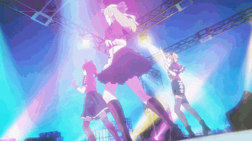 a group of girls are dancing on a stage with purple lights