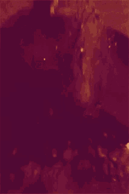 a woman with long hair is standing in a dark room holding a sword .