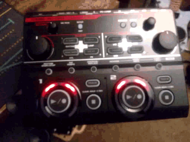 a black and red device with the number 1 and 2 on the top