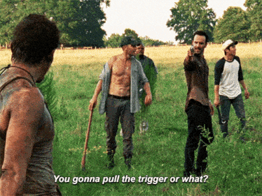 a group of men are standing in a grassy field and one of them says " you gonna pull the trigger or what ? "