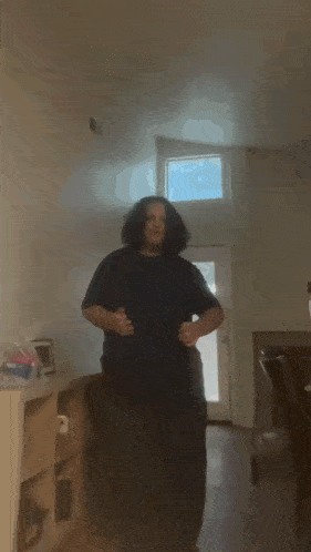 a group of people are dancing in a hallway .