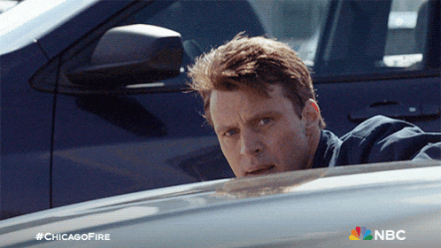 a man in a car with the hashtag #chicagofire on the bottom