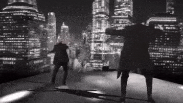 two men are dancing in front of a city skyline
