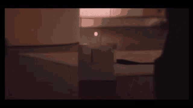 a candle is lit in a dark room with a black background