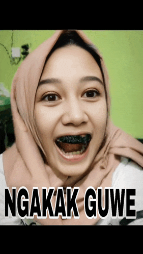 a woman with a scarf around her head has black teeth and the words ngakak gue on the bottom