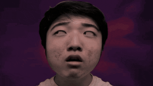 a close up of a man 's face with a surprised expression