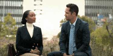 a man and a woman are sitting next to each other and talking