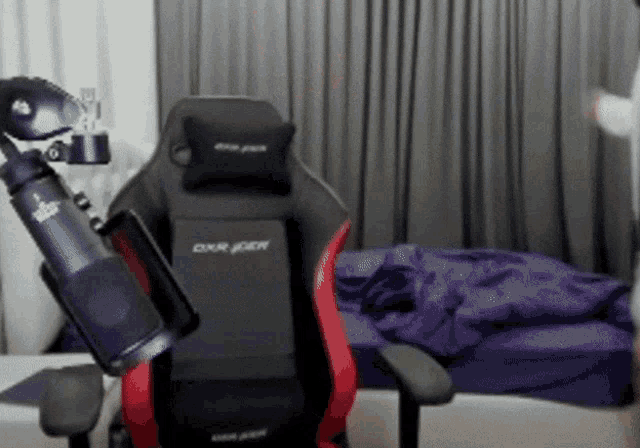 a black and red dxr gaming chair in a bedroom