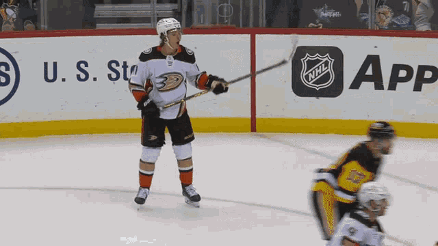 a hockey player stands on the ice in front of a u.s. state advertisement