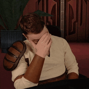 a man is covering his face with his hand