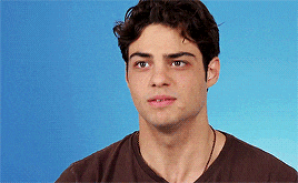a close up of a man 's face against a blue background .