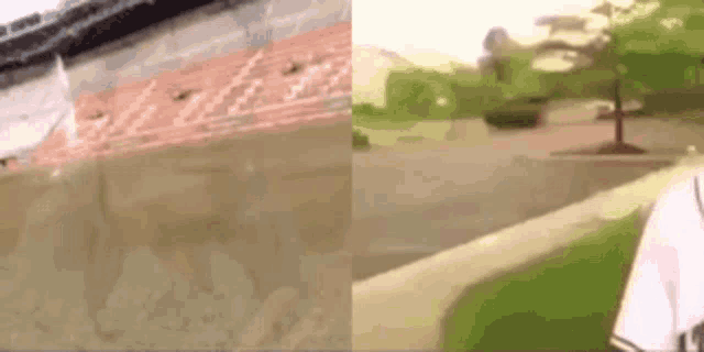 a man is walking down a sidewalk in front of a stadium and a tree .