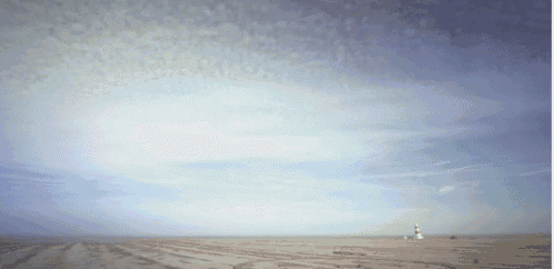a lighthouse in the distance with a blue sky