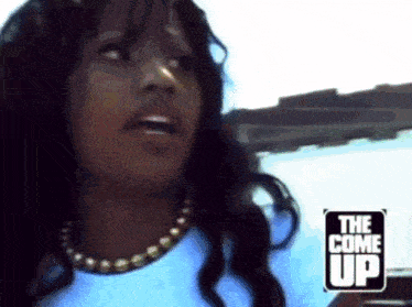 a woman in a car with a sign that says the come up behind her