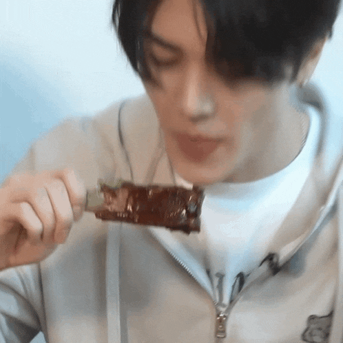 a close up of a person eating a piece of food