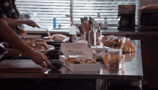 a kitchen counter with a box of food and a ctv logo
