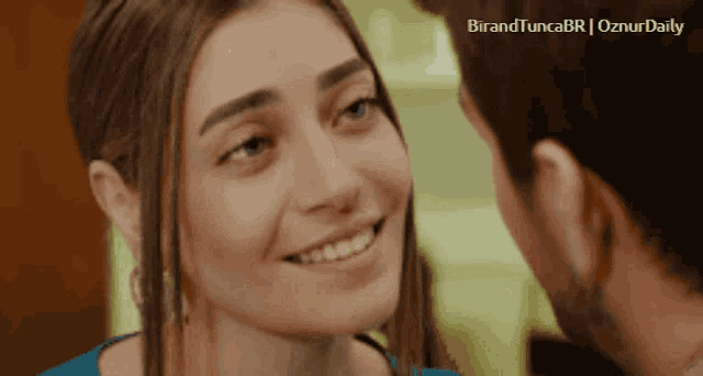 a man and a woman are looking at each other with the words birandtuncabr on the bottom left