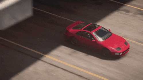 a red car is driving down the road with an arrow pointing to the right