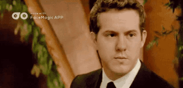 a man in a suit and tie with facemagic app written on the bottom right