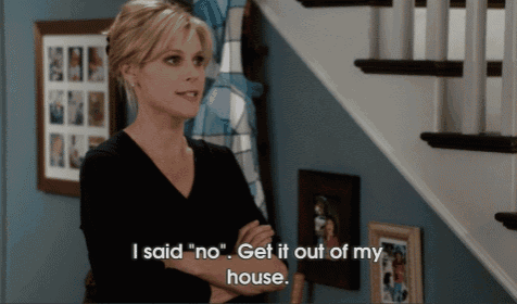 a woman standing in front of a staircase says " i said " no " get it out of my house "