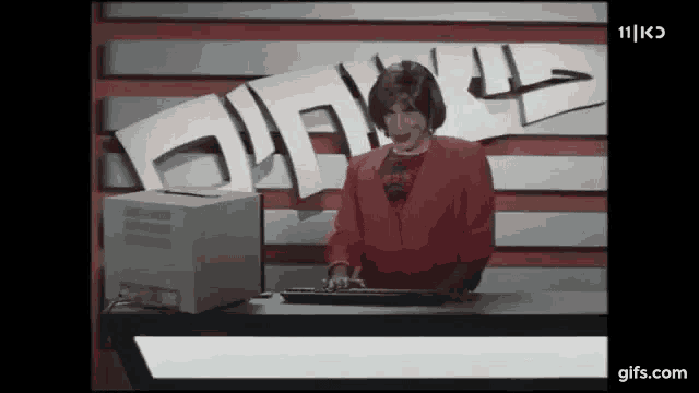 a woman is typing on a keyboard in front of a sign that says 11 k