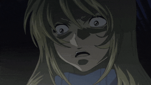 a close up of a woman 's face with a very angry look on her face