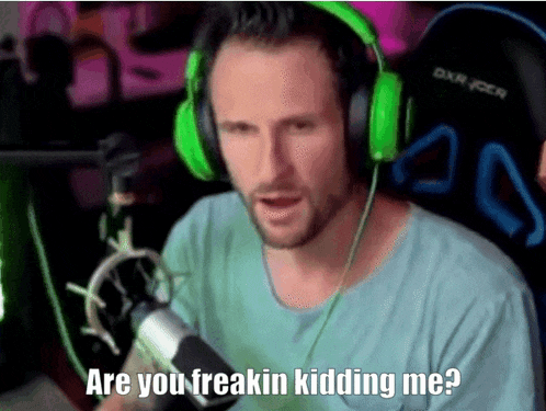 a man wearing green headphones is talking into a microphone and says " are you freakin kidding me "