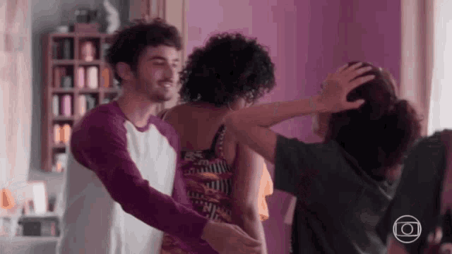 a man and a woman are hugging each other in a room .