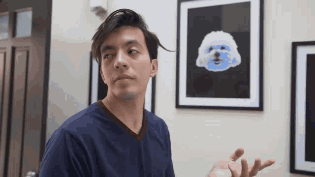a man stands in front of a picture of a dog