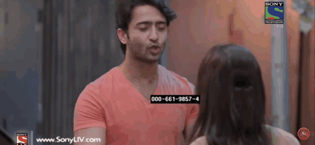 a man in a pink shirt is talking to a woman on a sony tv channel