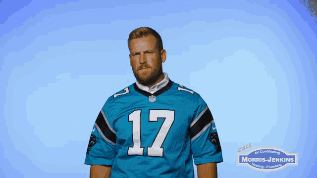 a man wearing a blue jersey with the number 17