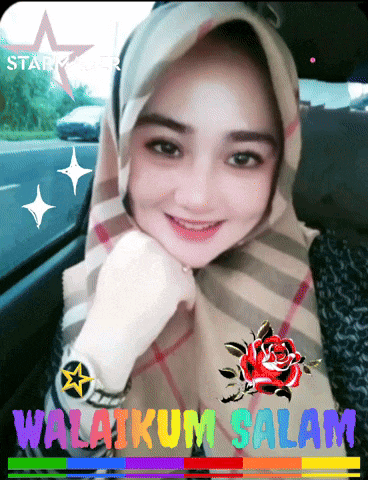 a woman wearing a hijab is sitting in a car next to a sign that says ' selamat ' on it