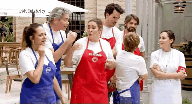 a group of people wearing aprons one of which says capitan on it
