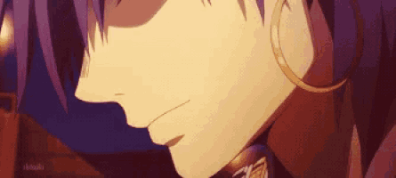 a close up of a person 's face with purple hair and gold hoop earrings .