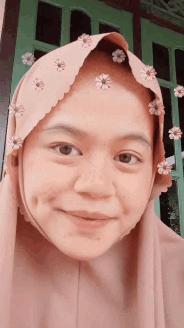 a woman wearing a veil with flowers on it
