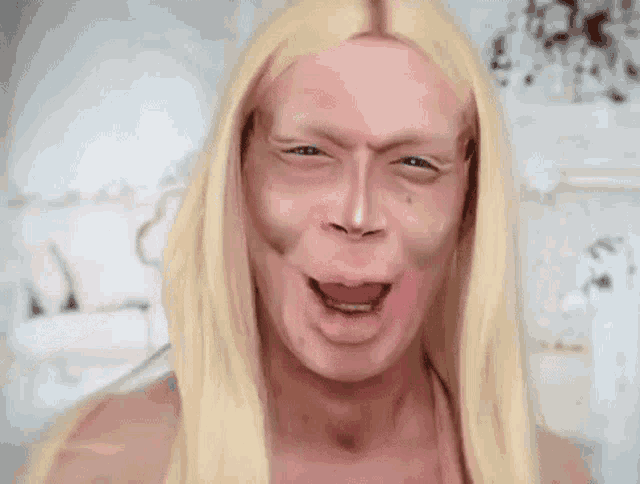 a painting of a man with long blonde hair making a face