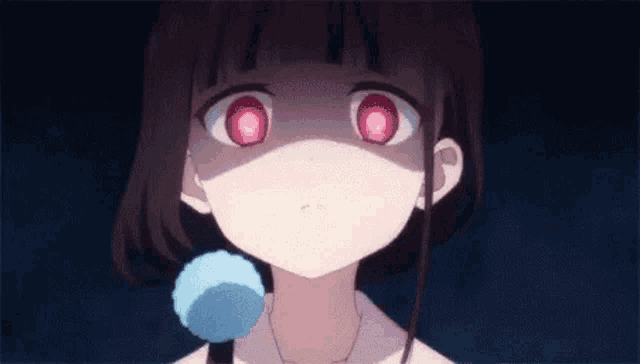 a close up of a girl with red eyes and a blue ball in her hand .